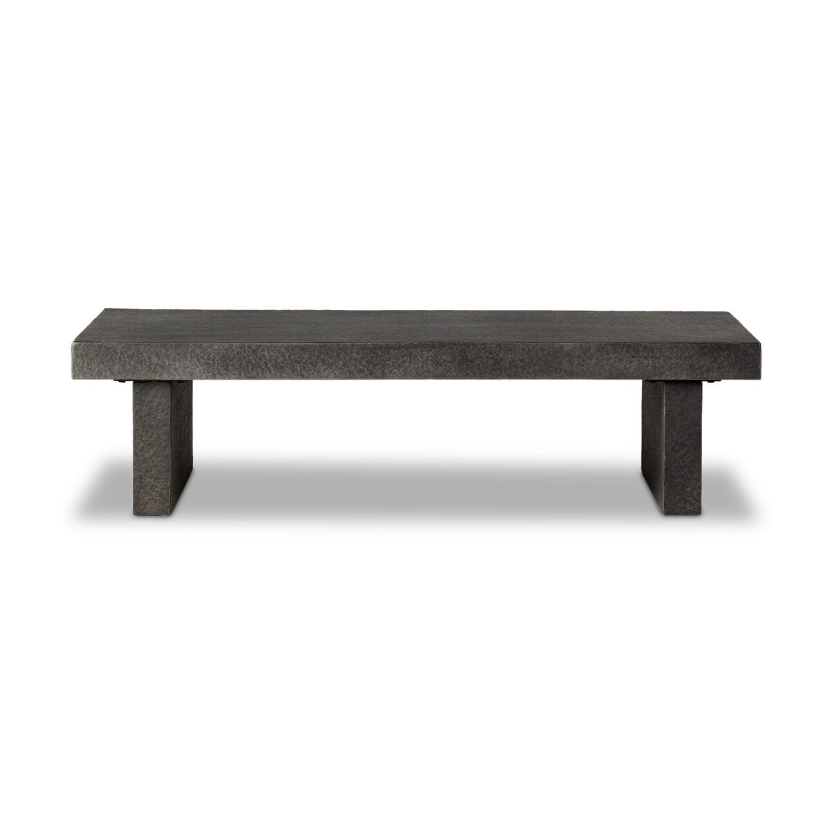 The Distressed Coffee Table is a minimalist, rectangular dark gray bench with a solid flat top and two block-style legs, resembling concrete, displayed against a white background.