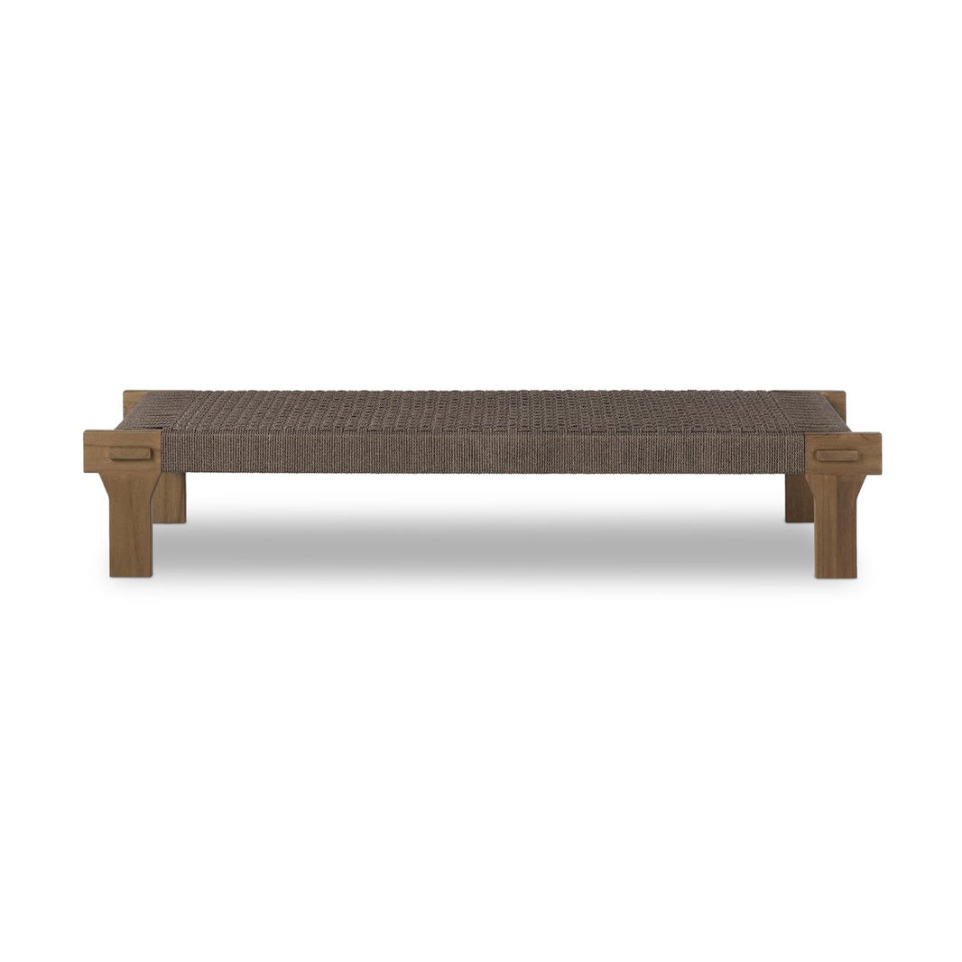 The Moxie Outdoor Coffee Table features a woven brown seat and sturdy rectangular legs, making it a versatile piece ideal beside a sofa. Shown here against a white background.