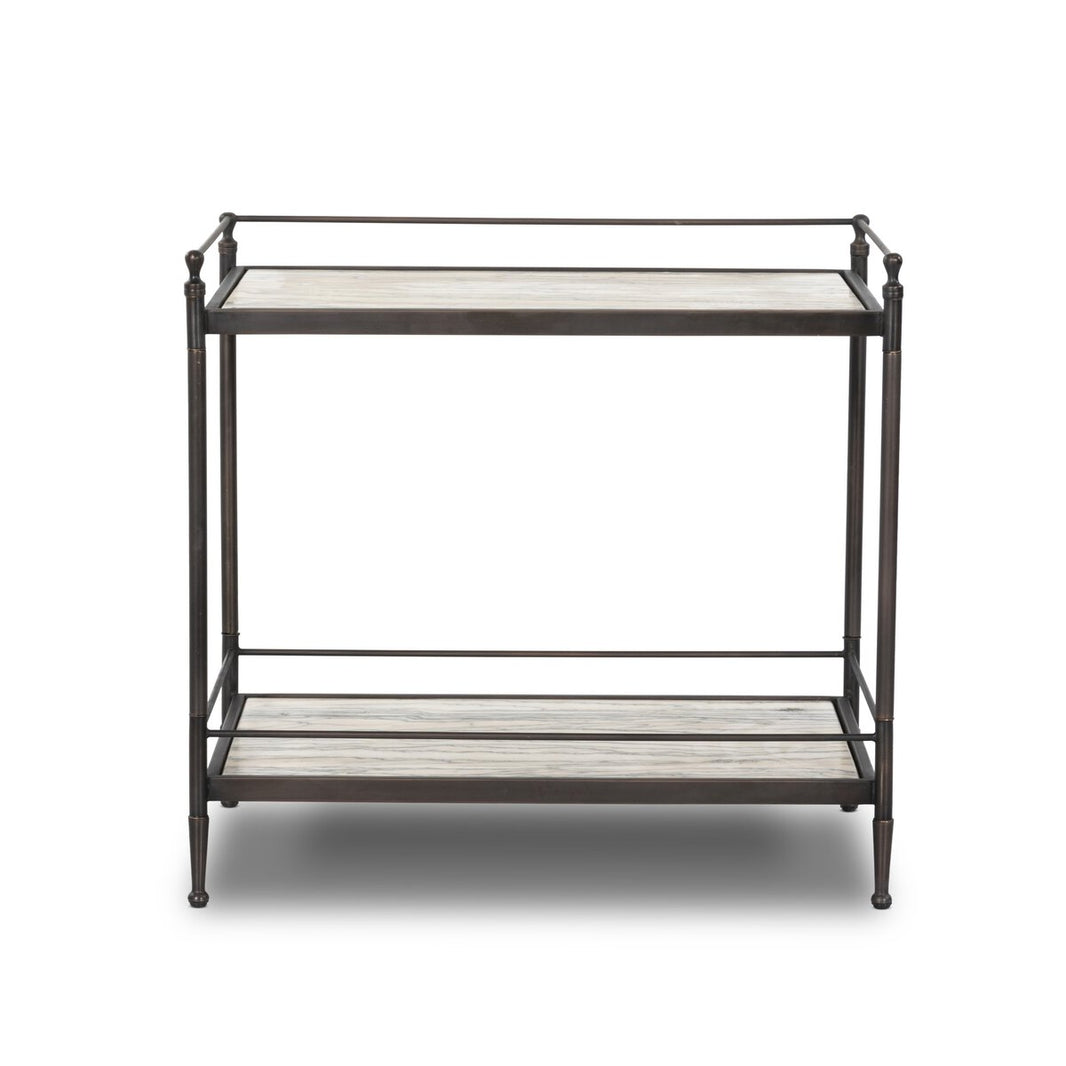 The Two-Tier Metal Nightstand features heritage charm with a light wood surface on both shelves and an open-frame design with slim, dark metal legs and railings.