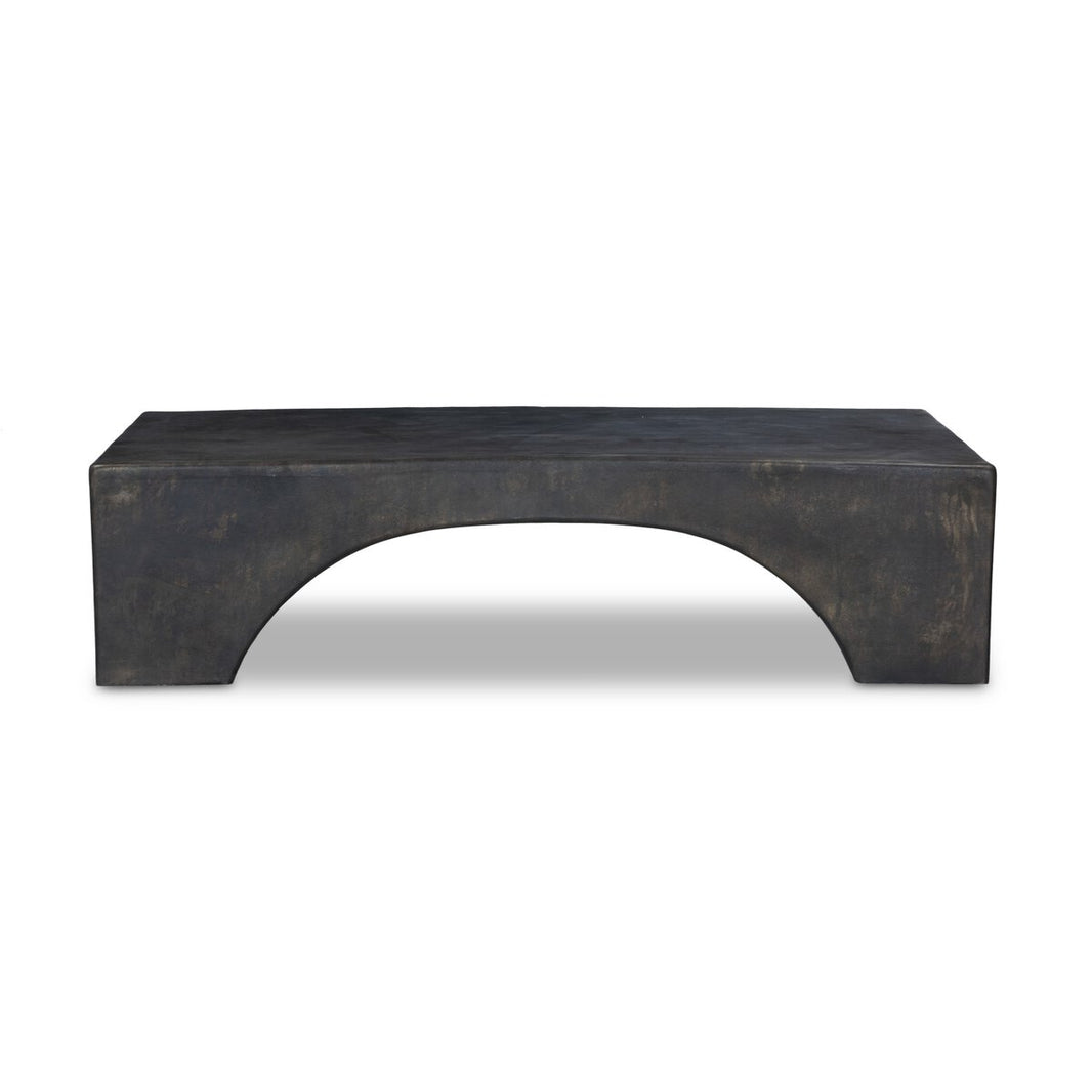 The Arched Base Outdoor Coffee Table2 is a rectangular, dark-hued table with a smooth surface and a large arched cutout in the base, showcasing a bold waterfall silhouette, set on a white background.