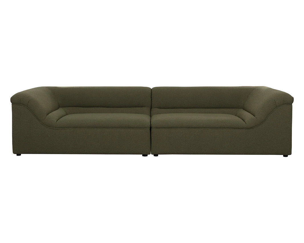 The Curved Upholstered Sofa is a modern, olive green piece featuring a low backrest, wide armrests, and two connected seats, displayed from the front.