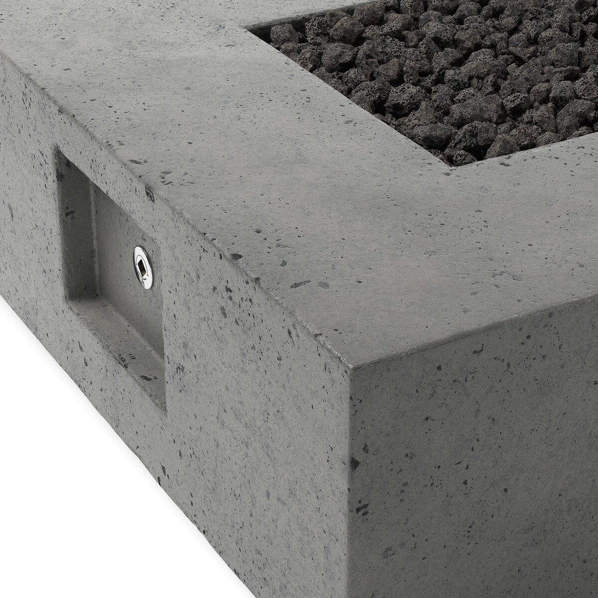 Close-up of a modern Square Outdoor Fire Table made from glass-reinforced concrete, featuring a recessed control knob and a compartment filled with dark, porous lava rocks.