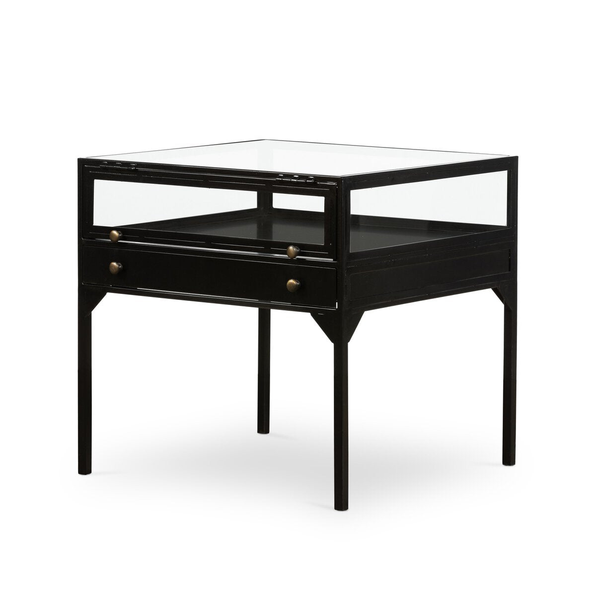 The Shadowbox End Table is a modern matte-black metal piece with a glass top and sides, two small drawers with brass knobs, and four straight legs—ideal for displaying decor in style.