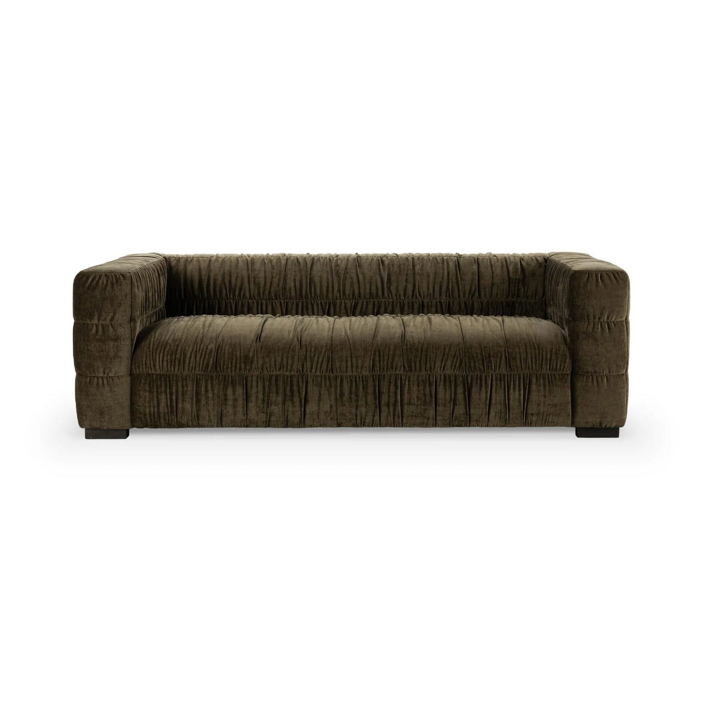The Ruched Upholstered Sofa features dark brown velvet, a low back and arms, gathered fabric texture, and block-style legs, offering modern artistry and elegance.