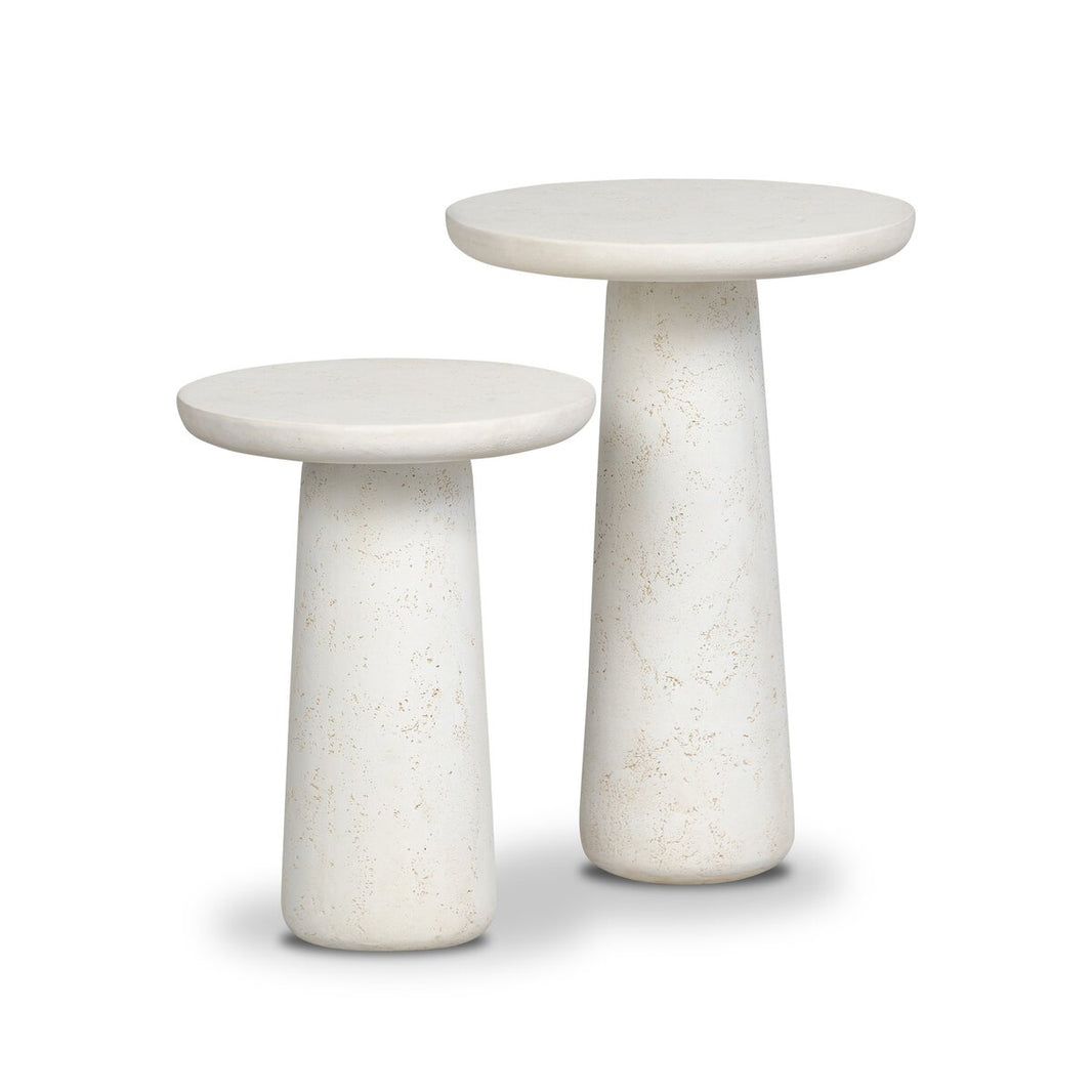 Two round, white Concrete Outdoor Nesting End Tables of different heights with sleek pedestal bases and flat tops are placed side by side on a white background.