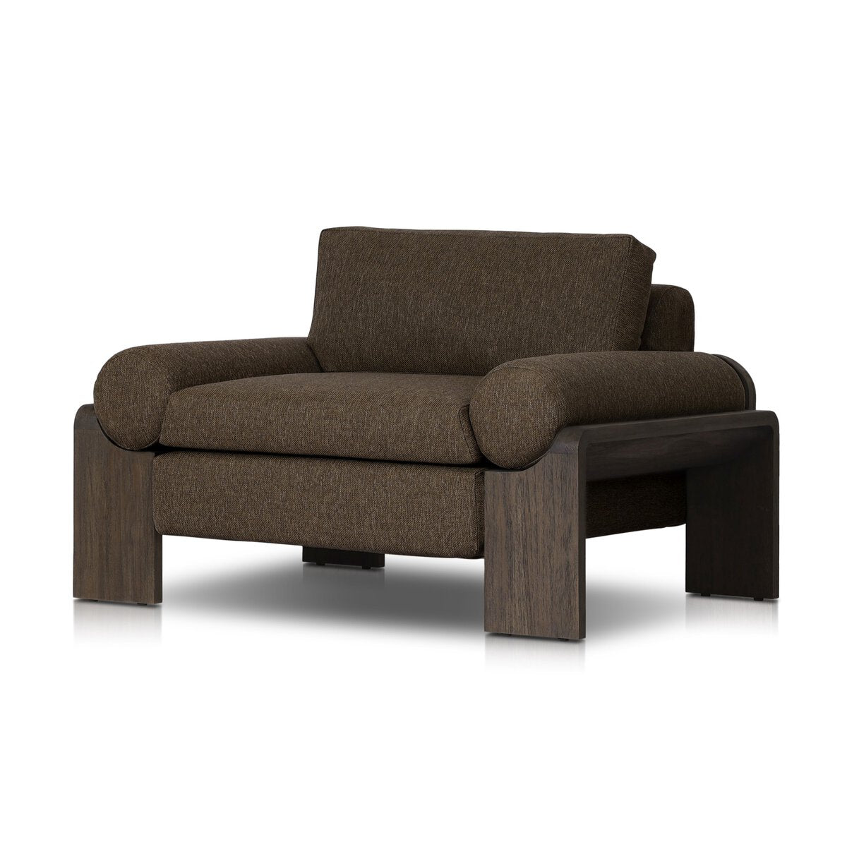 The Joette Outdoor Chair features thick, dark brown upholstered cushions and wide, cylindrical armrests on a sturdy dark wood frame with curved legs—a stylish piece that suits most spaces and complements any decor.