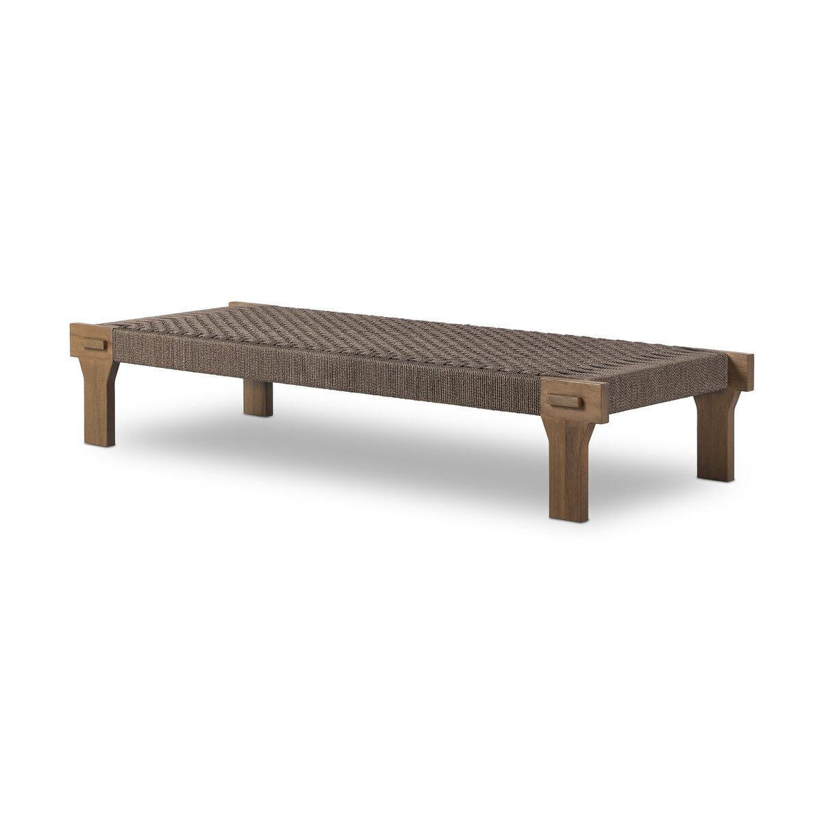 The Monochromatic Weaved Coffee Table features a rectangular design with a woven brown seat and sturdy solid teak legs, showcasing minimalist and modern Indonesian style.