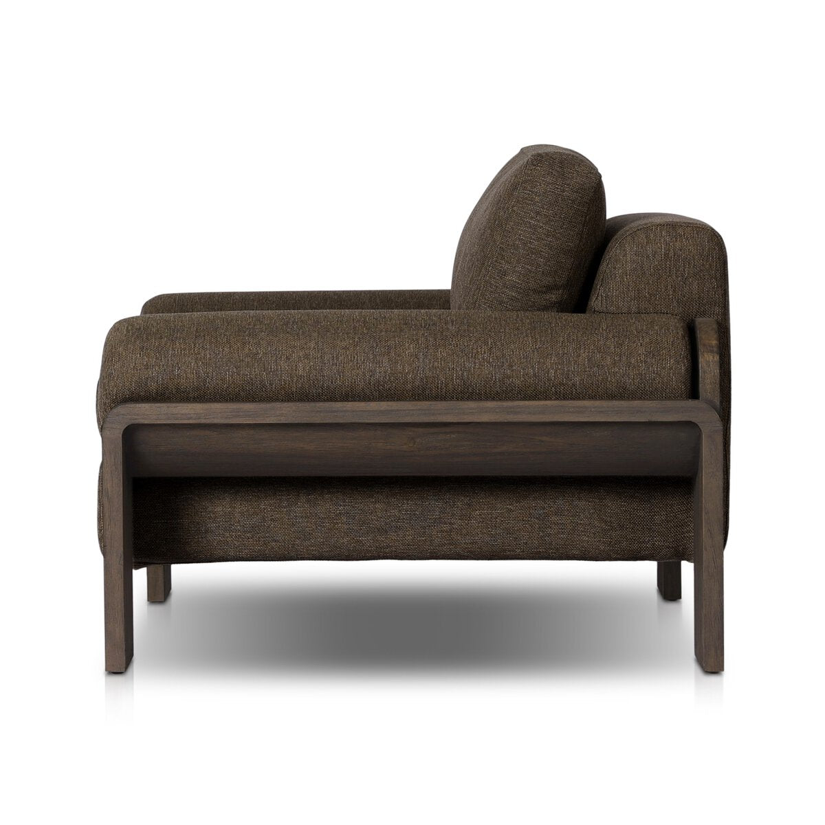 Side view of the Joette Outdoor Chair—a modern brown upholstered armchair with thick cushions, boxy design, and wood frame and legs—ideal for those coordinating furniture size in their space.