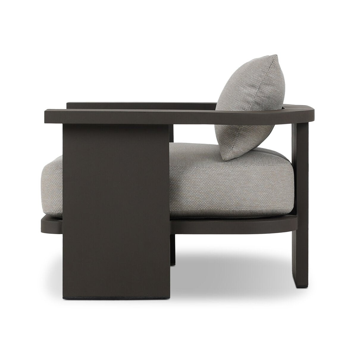 The Three Legged Outdoor Chair features Italian upholstery, a cozy pillow, and is crafted from high-performance fabric for outdoor use.