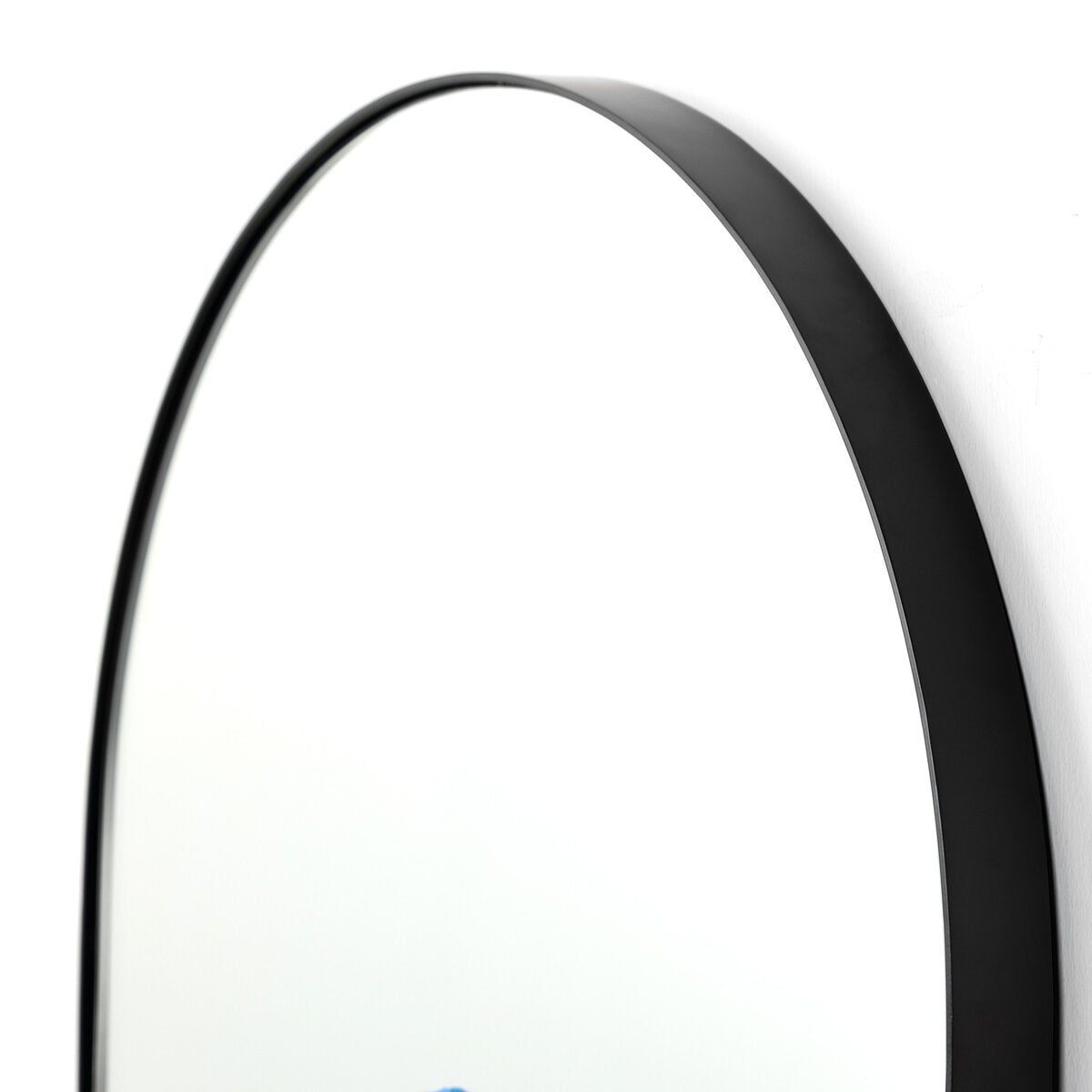Close-up of the top edge of the Georgina Floor Mirror, featuring a thin black metal frame against a white background; ideal dimensions for pairing with a 32-inch wide or 32x80 door.