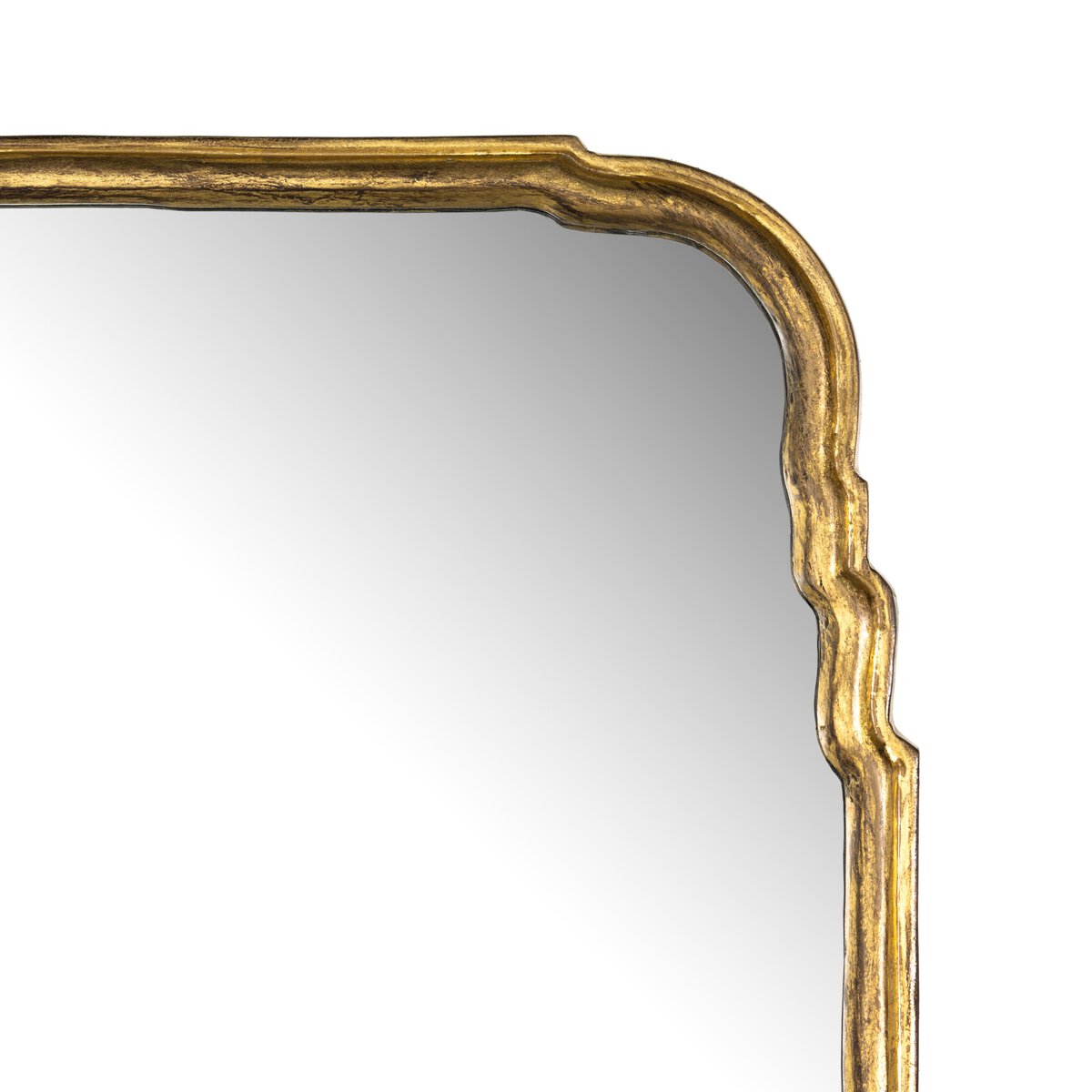 A close-up of the Loire Grand Floor Mirror’s top right corner shows its ornate gold frame with curved, wavy edges. The mirror measures 52x1.5x71.5 and reflects a plain, light background.