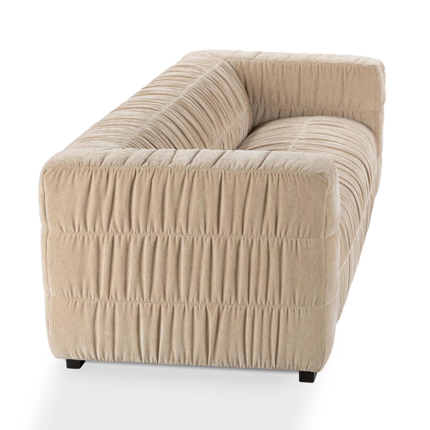 The Ruched Upholstered Sofa features modern artistry with a boxy silhouette, low-profile arms and back, and elegant ruched upholstery, shown from the back and side on a white background.