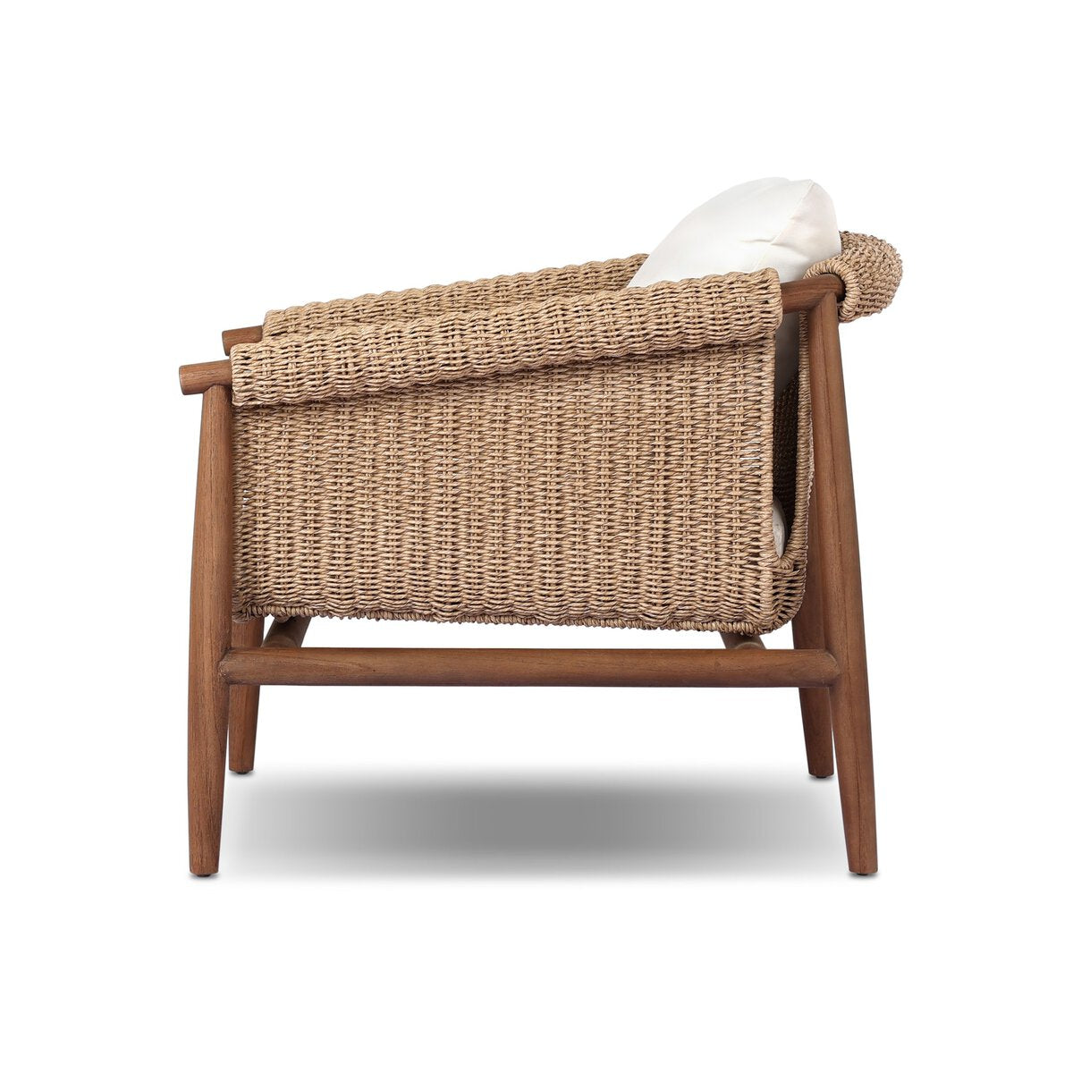 Side view of the Woven Outdoor Chair featuring a woven faux hyacinth bucket seat, wooden frame and legs, and a white seat cushion. This vintage-inspired piece is displayed against a white background.