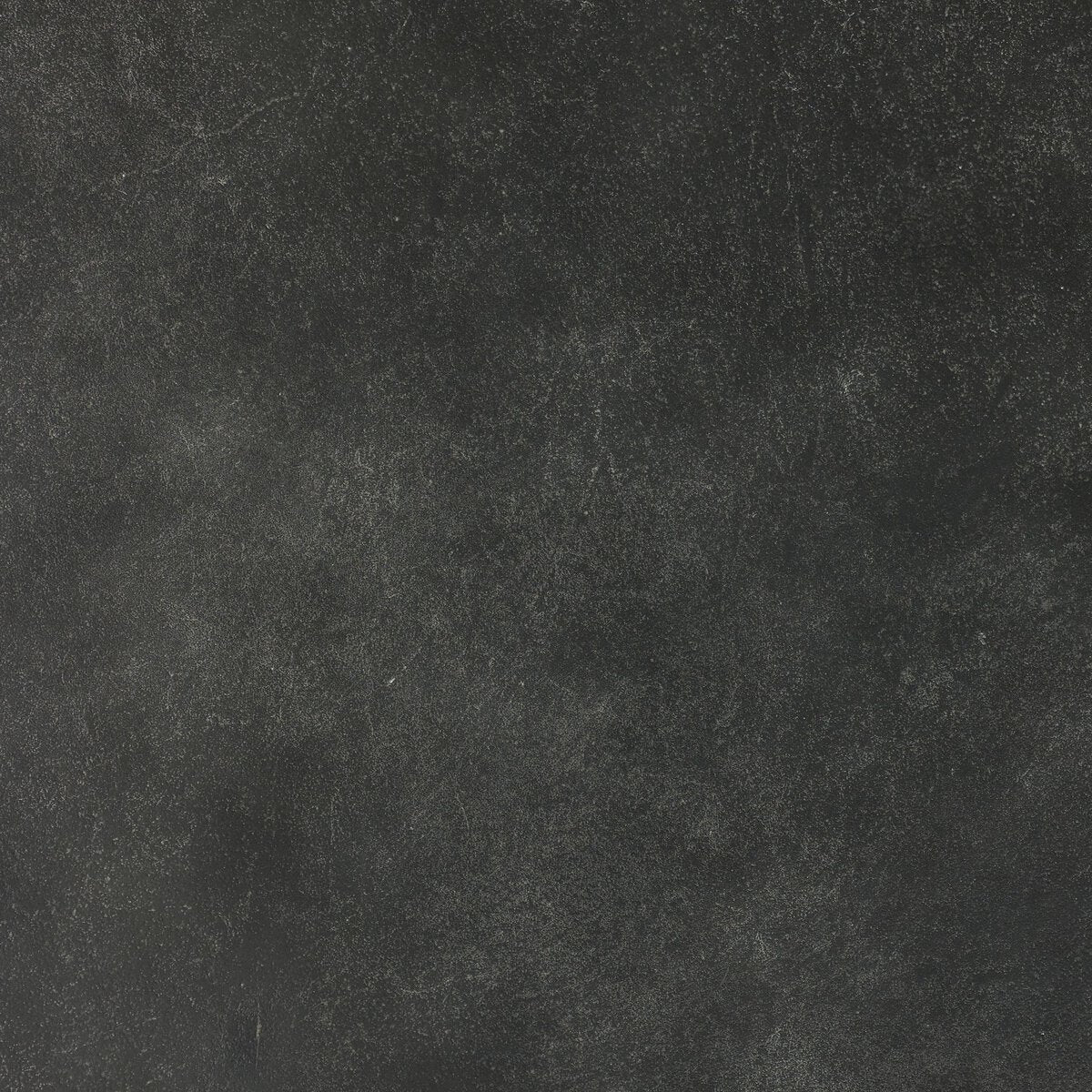 The Aged Aluminum Outdoor Dining Table features a textured black surface with subtle gray speckles, offering an aged aluminum look that adds character to any indoor or outdoor dining setting.