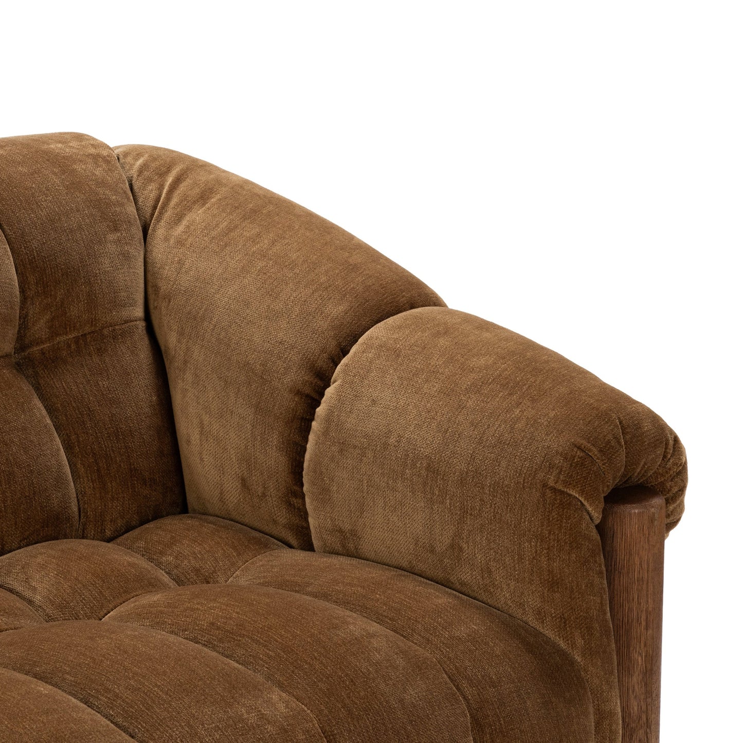 Close-up of the Plush Upholstered Sofa’s upper corner features soft brown polyester fabric, visible stitching, and a brushed oak wood frame detail.