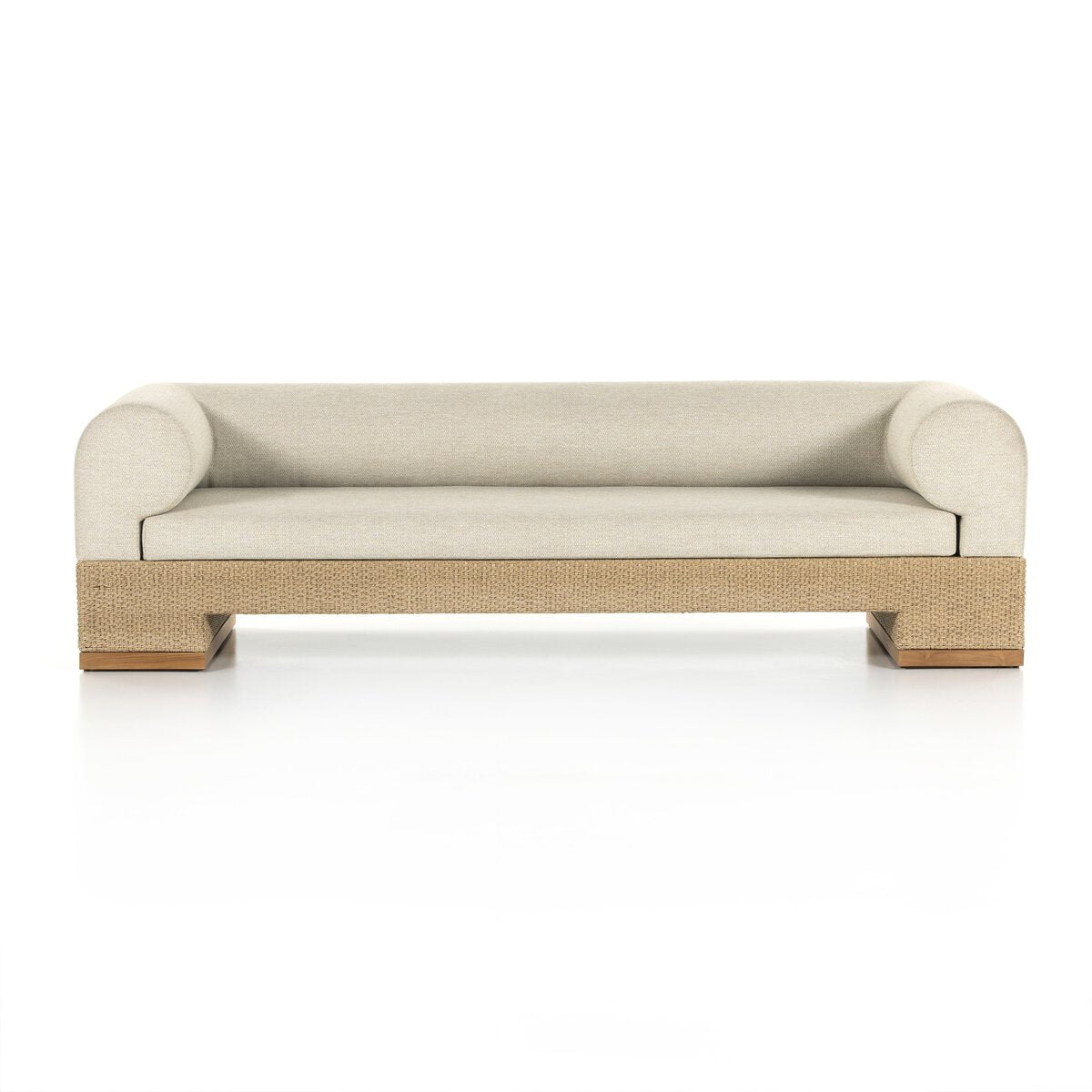 The Wicker Base Outdoor Sofa features modern light beige upholstery, low rounded arms, and a rectangular wicker base for stylish outdoor seating, displayed against a white background.