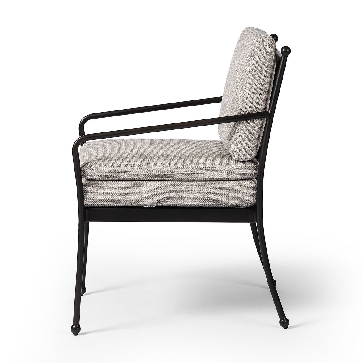Side view of the French Decco Outdoor Dining Armchair featuring a black metal frame, slender legs, and light gray double seat cushioning, displayed against a white background.