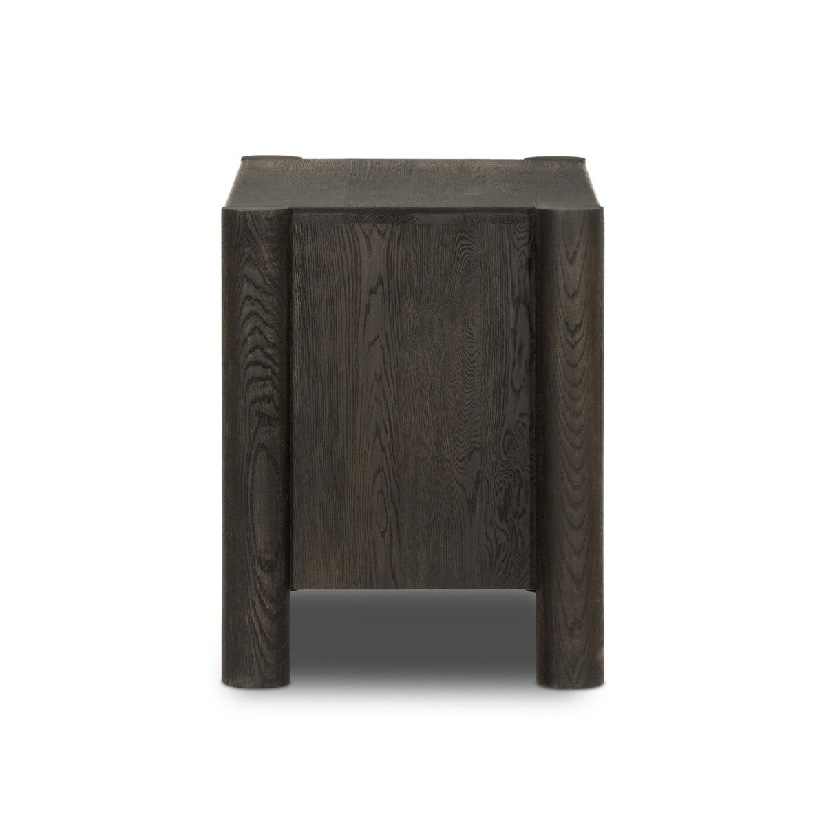 The Primitive Nightstand is a modern oak side table with a cocoa finish, featuring a rectangular top and rounded cylinder legs, shown from the front against a white background.