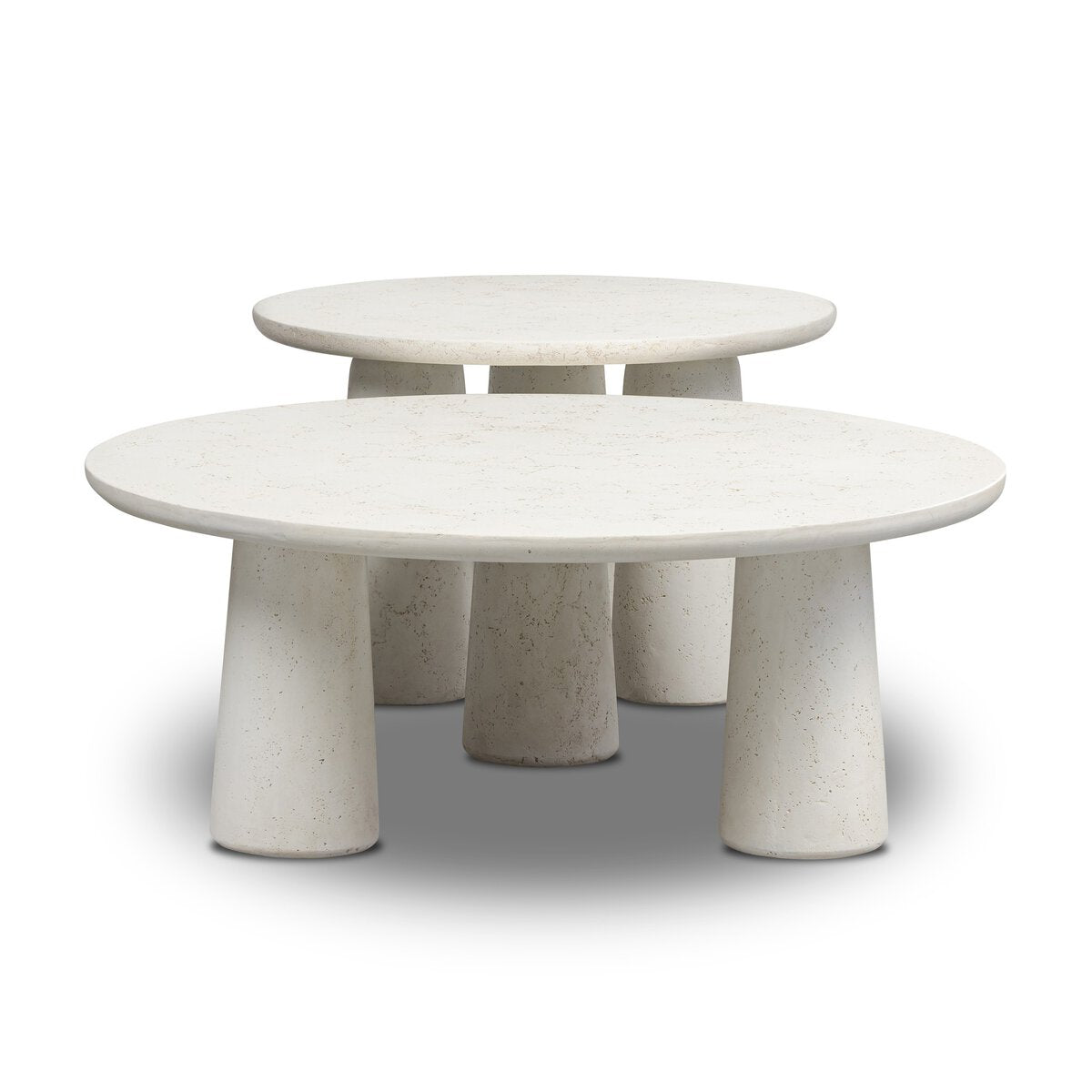 The Concrete Outdoor Nesting Coffee Tables feature two round, white cast ivory tables with thick three-legged bases—one slightly smaller and nested behind the other—creating a chic look against a white background.