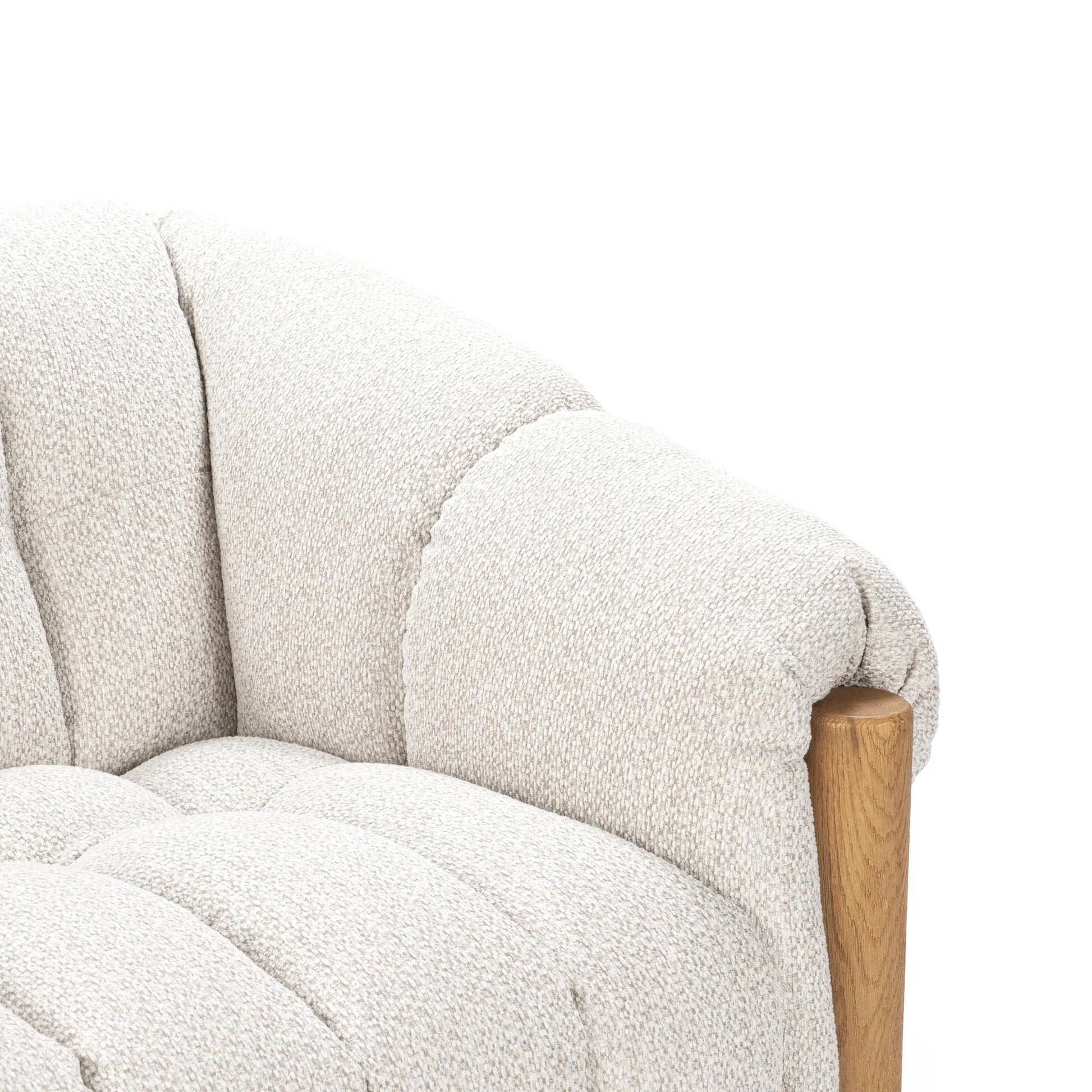 Close-up of the Plush Upholstered Sofa in textured light beige polyester fabric with a rounded, plush backrest and smooth brushed oak wood accent on the armrest, set against a plain white background.
