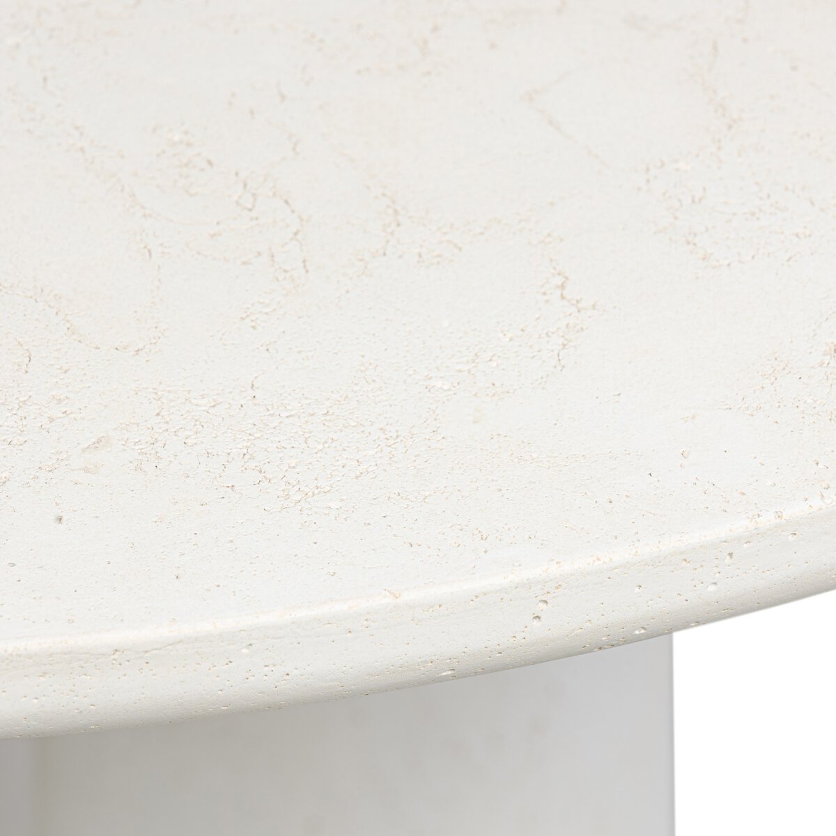 Close-up of the Concrete Pedestal Dining Table’s round, off-white cast concrete top featuring a smooth, stone-like pattern—perfect for outdoor dining and pairs well with pedestal legs.