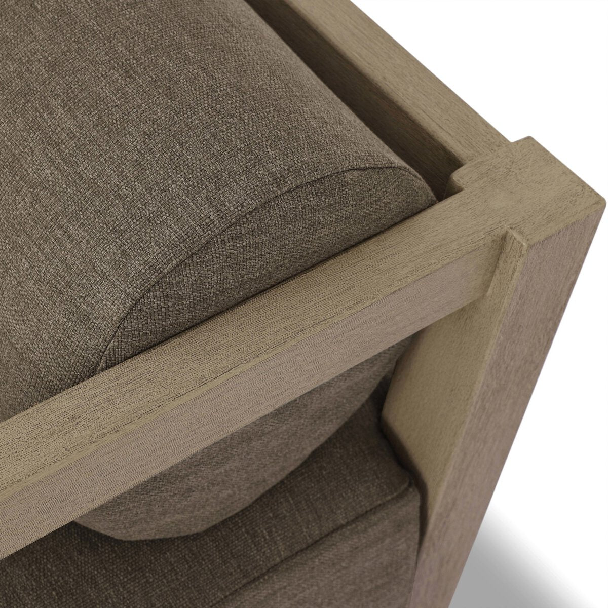 Close-up of the Bolster Back Outdoor Sectional, showcasing its textured brown antimicrobial cushion and minimalist light wood frame with clean, angled edges, crafted from FSC-certified teak.