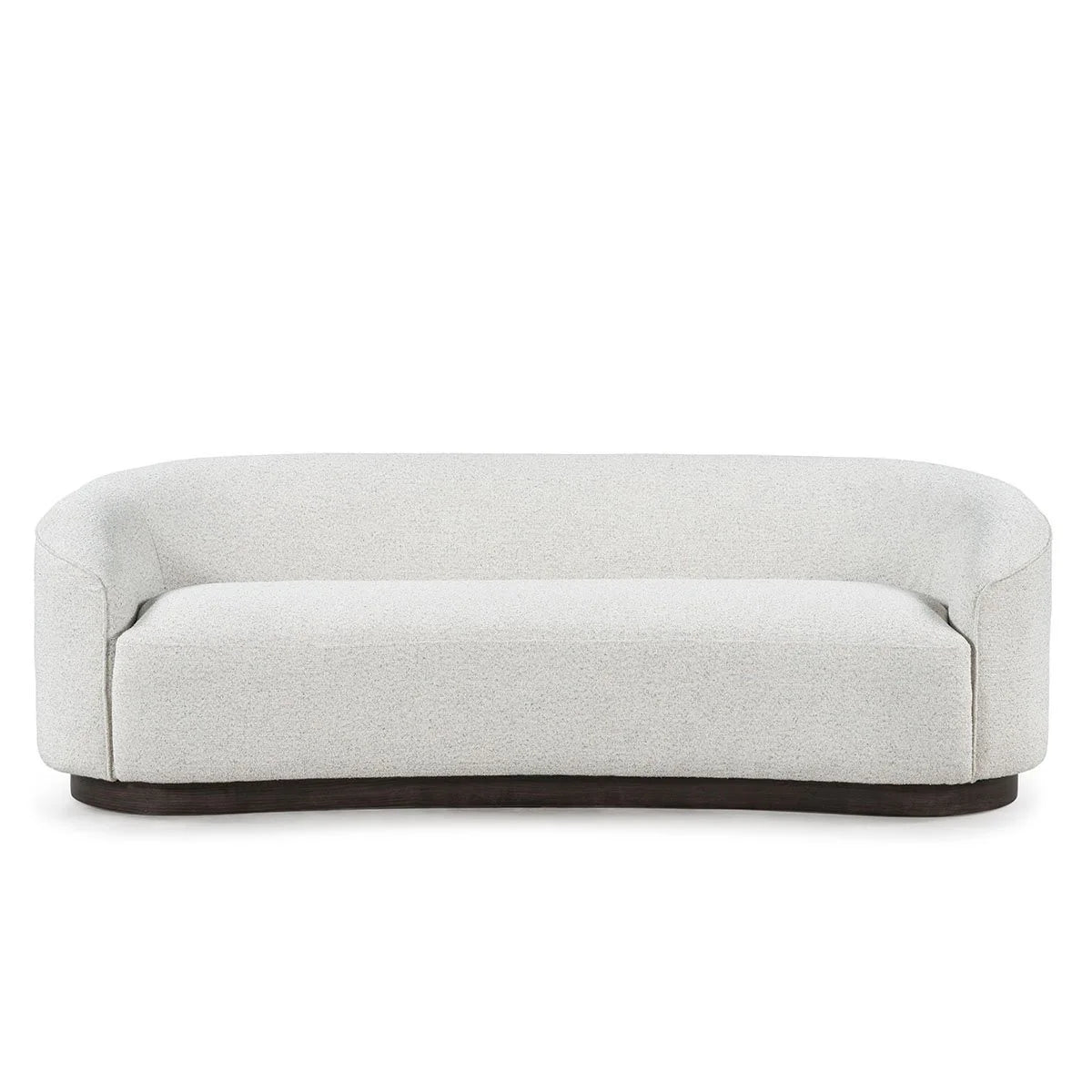 The Curved Sofa features a modern, low-back design with armrests, upholstered in light gray fabric, and set on a dark, rounded base against a white background.