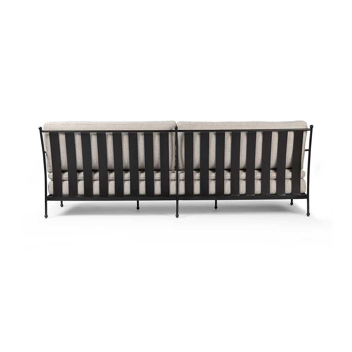 The French Decco Outdoor Sofa features a black metal frame with vertical slats, double light beige seat cushions, and visible legs. Its minimalist design offers a clean, open look ideal for modern patio spaces.