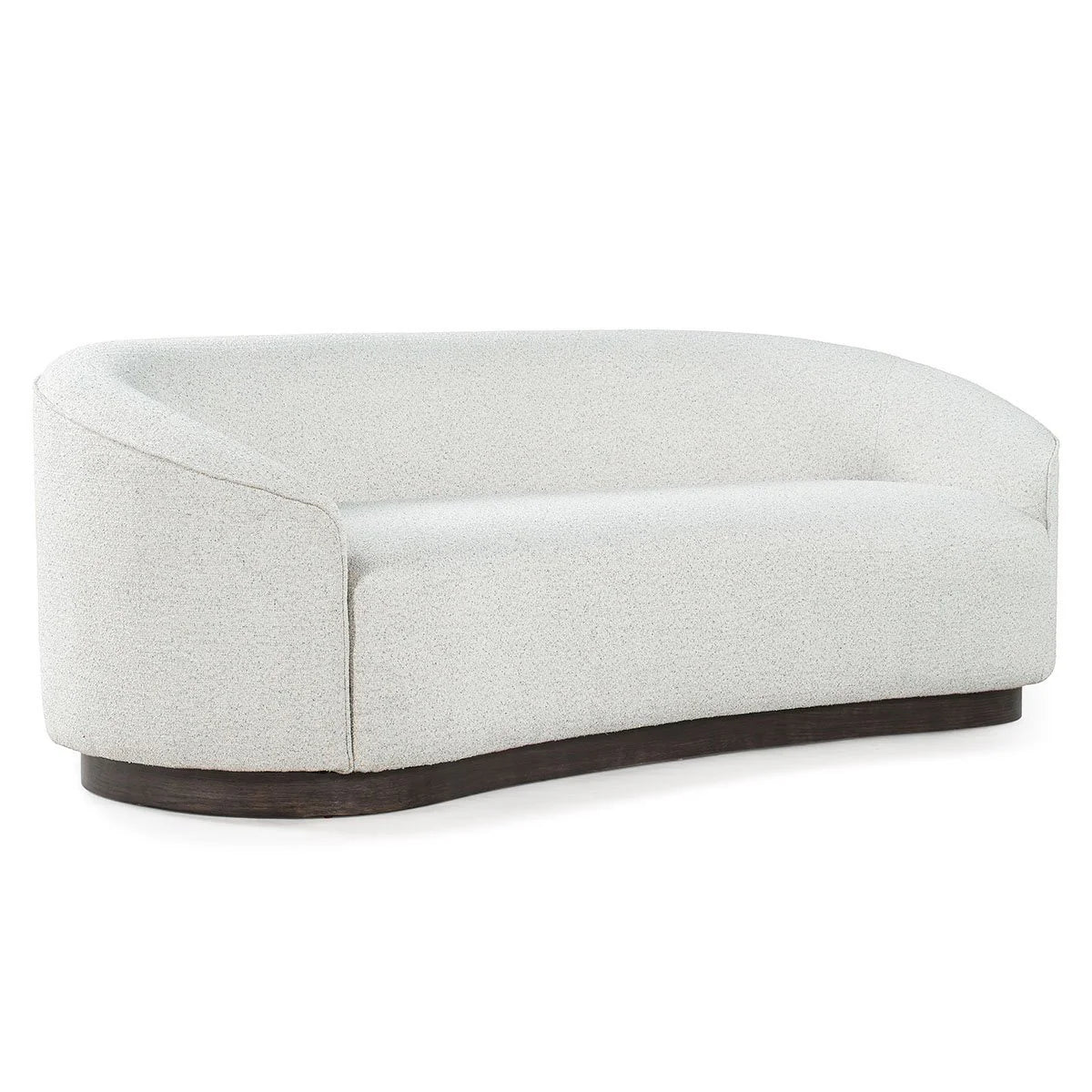 The Curved Sofa boasts a sculptural design with a curved white silhouette, low backrest and armrests, upholstered in textured fabric on a dark wooden base.
