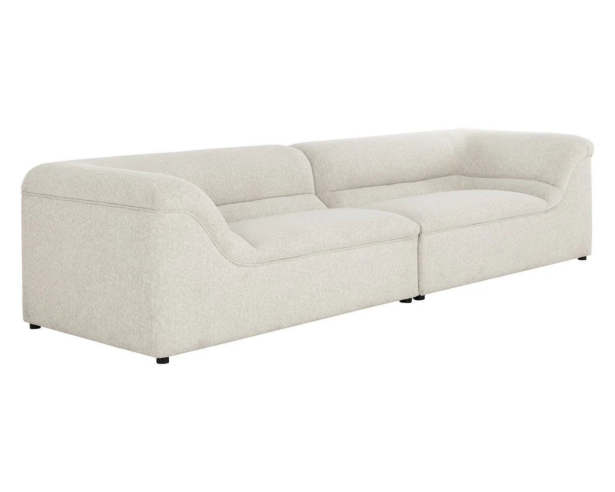 The Curved Upholstered Sofa features plush dove cream seating, a low backrest, gently curved armrests, and short black legs, all showcased against a white background.
