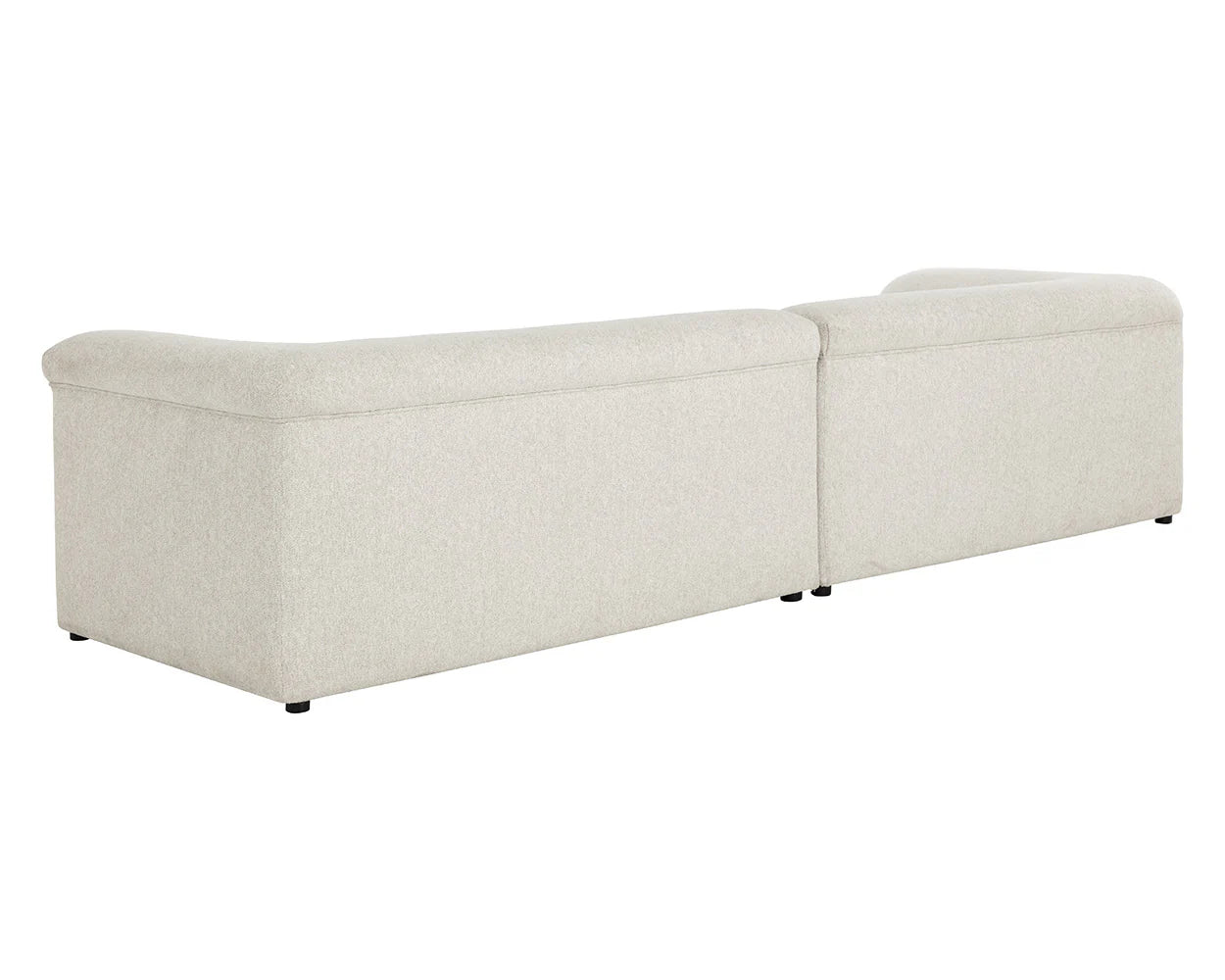 The Curved Upholstered Sofa is a light gray, contemporary sectional viewed from the back, with clean lines, smooth upholstery, low black feet, and two connected pieces for versatile seating in a modern dove cream finish.