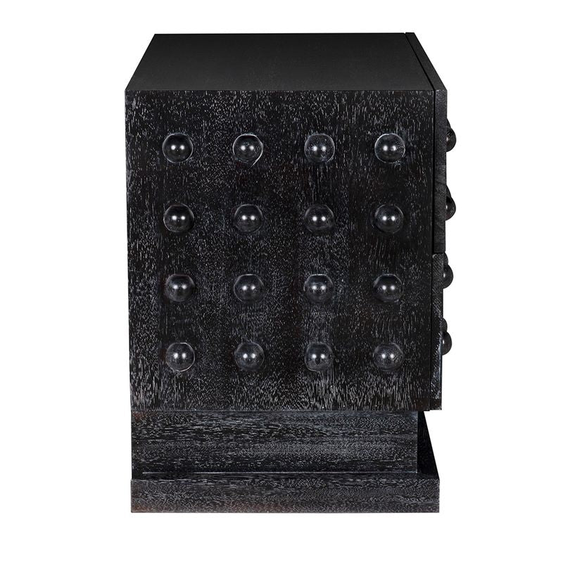 The Didier Sideboard, Black Walnut, is a black wooden cabinet with textured sides featuring a grid of raised round knobs, set on a rectangular base crafted from premium walnut.