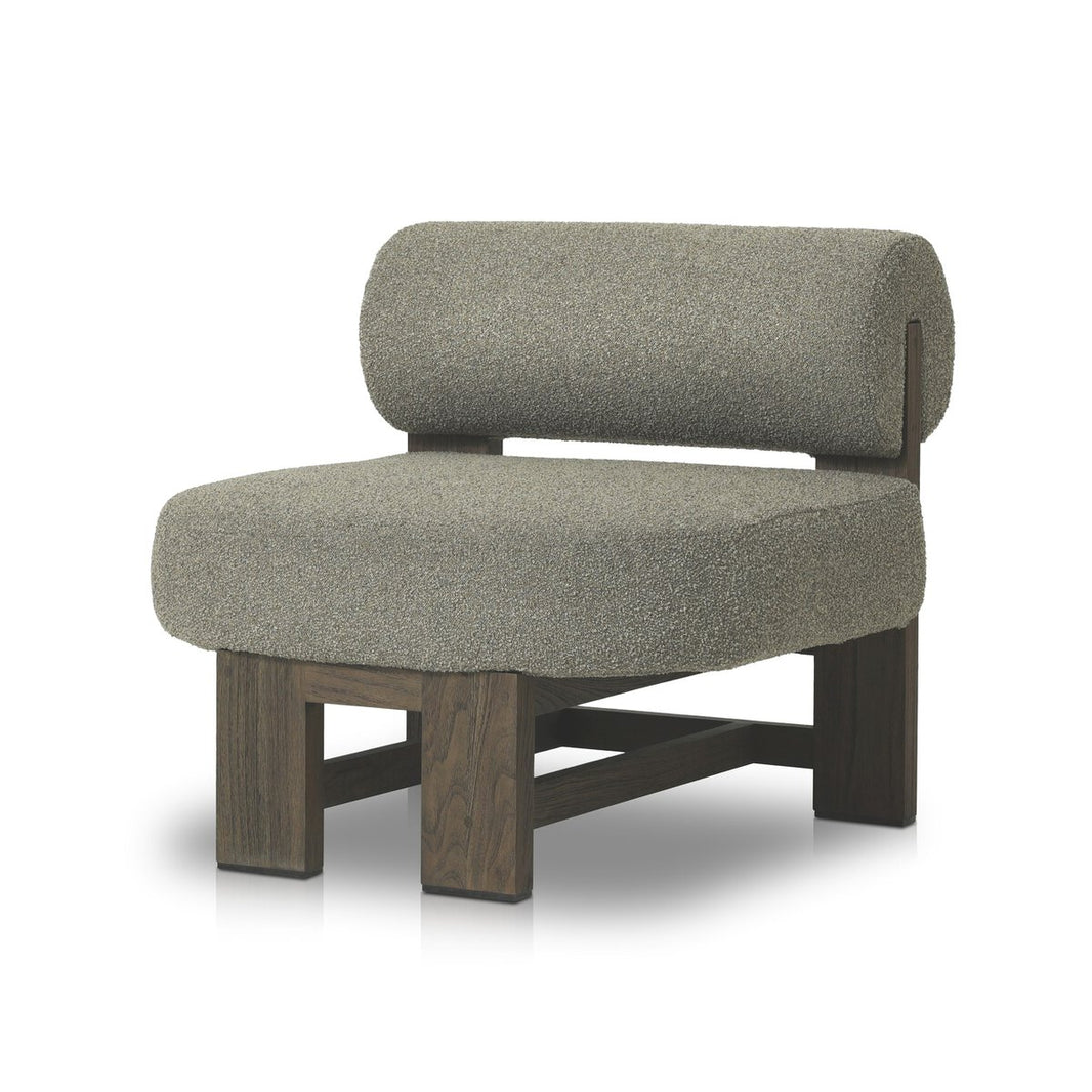 The Sculptured Round Bolster Outdoor Chair features a thick gray upholstered seat, cylindrical backrest, and dark FSC-certified teak frame with clean lines—making it a striking statement piece for outdoor spaces.