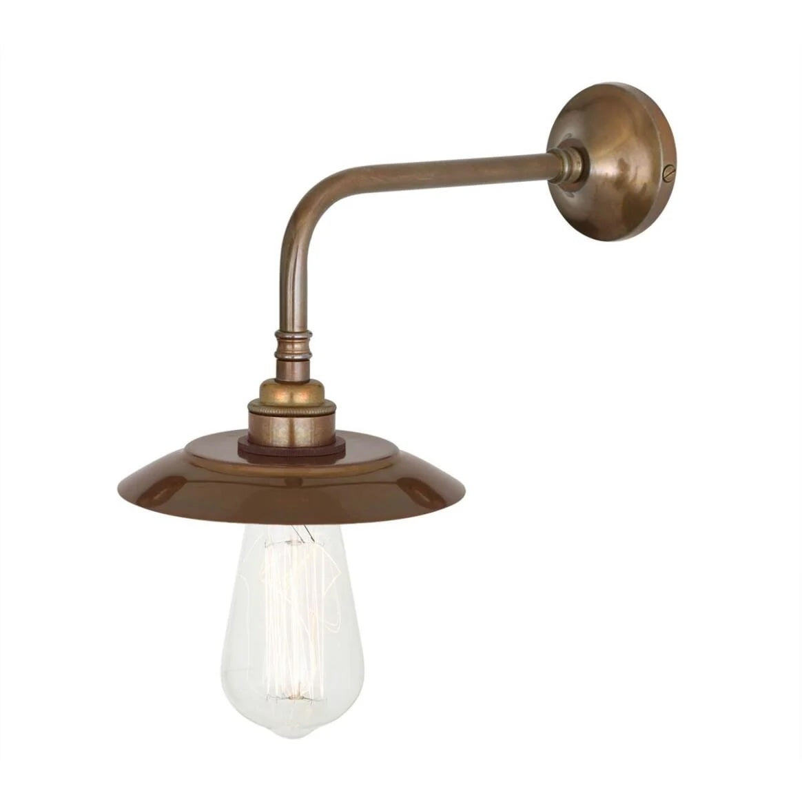 The Vintage Brass Industrial Sconce features a curved arm, round wall mount, flat circular shade, and exposed Edison bulb with a vintage brass finish. Made to order, it measures 6.25" wide by 7" high.