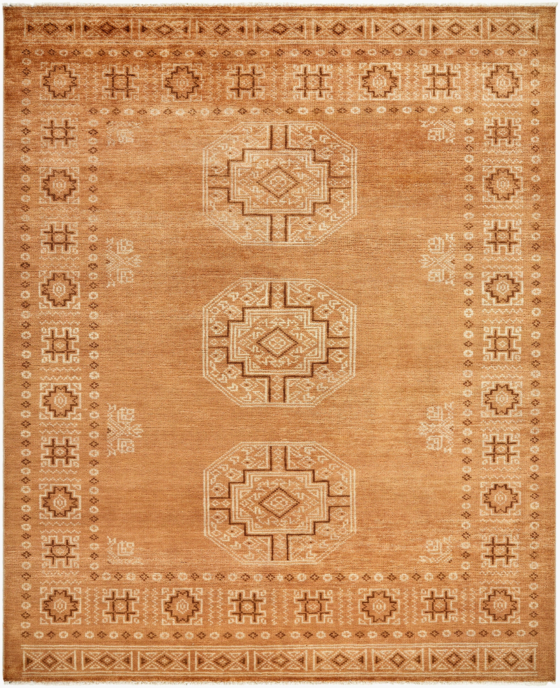 A burnt orange tribal runner rug (3' x 10') featuring three large central geometric medallions and an intricate border with repeating patterns and motifs.