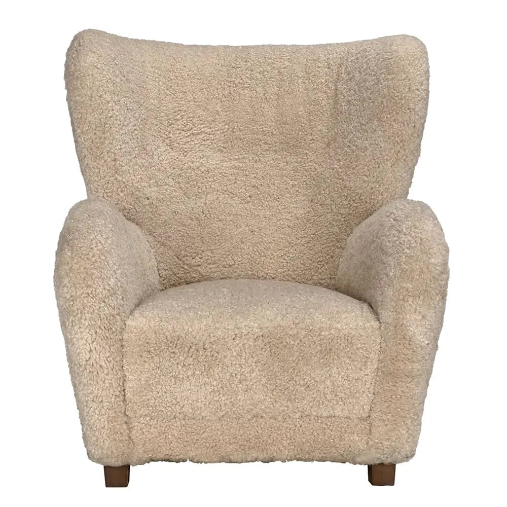 The Teddy Fleece Arm Chair features plush teddy-bear-like upholstery in beige, a high wide backrest, rounded armrests, and short wooden legs; measures 34W x 36D x 40H.