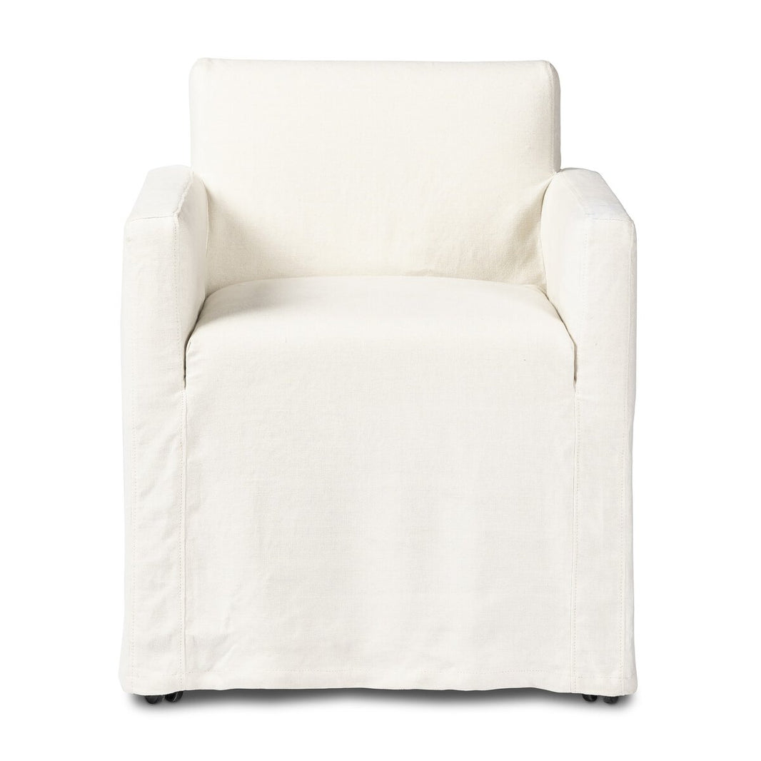 Front view of the Outdoor Slipcover Dining Chair, a modern white armchair with straight arms and a loose design. It features washable hemp upholstery, minimalist style, and small discreet wheels for easy movement.