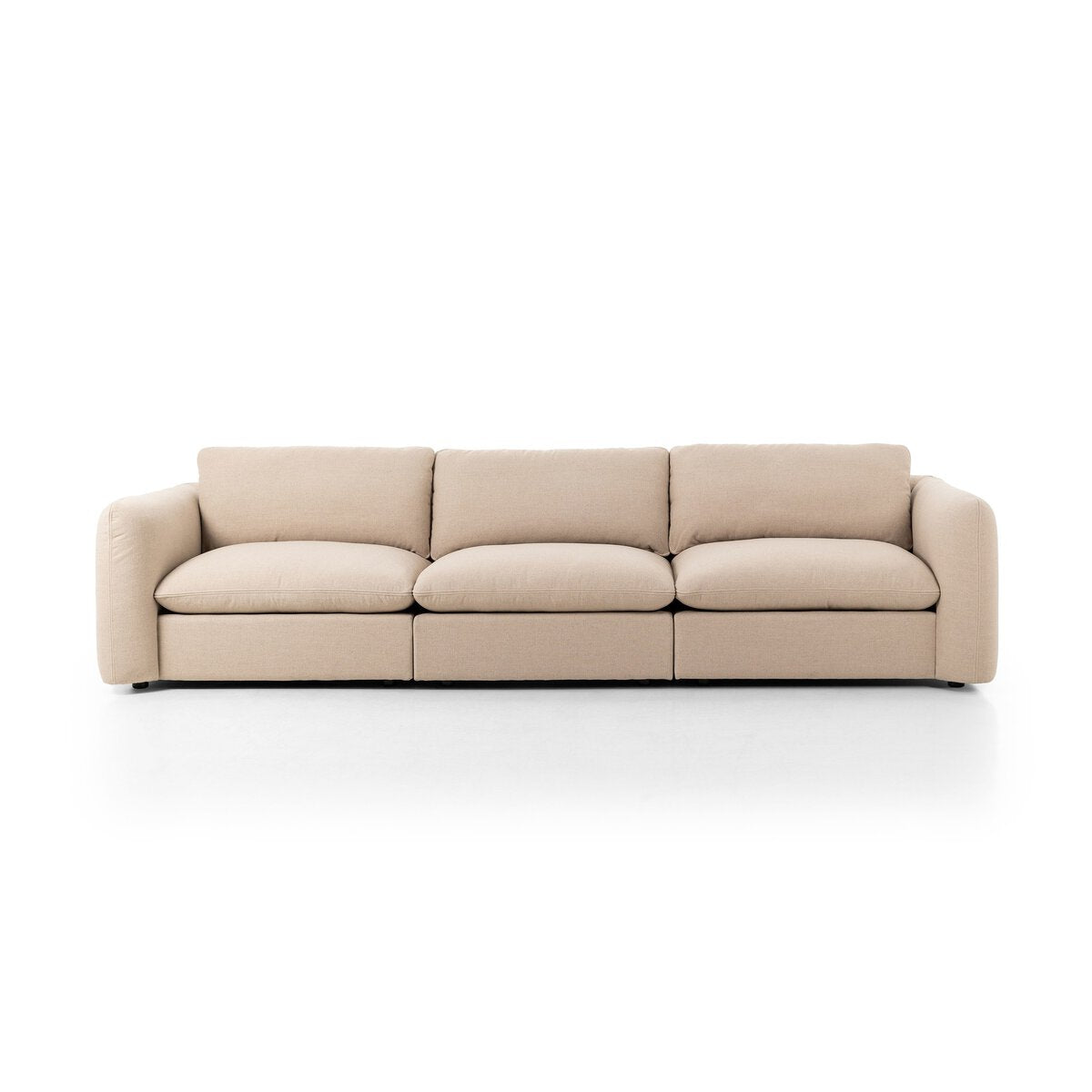 The Linen 3pc Sectional is a modern beige sofa with seating for three, featuring plush cushions and rounded armrests, shown against a plain white background.