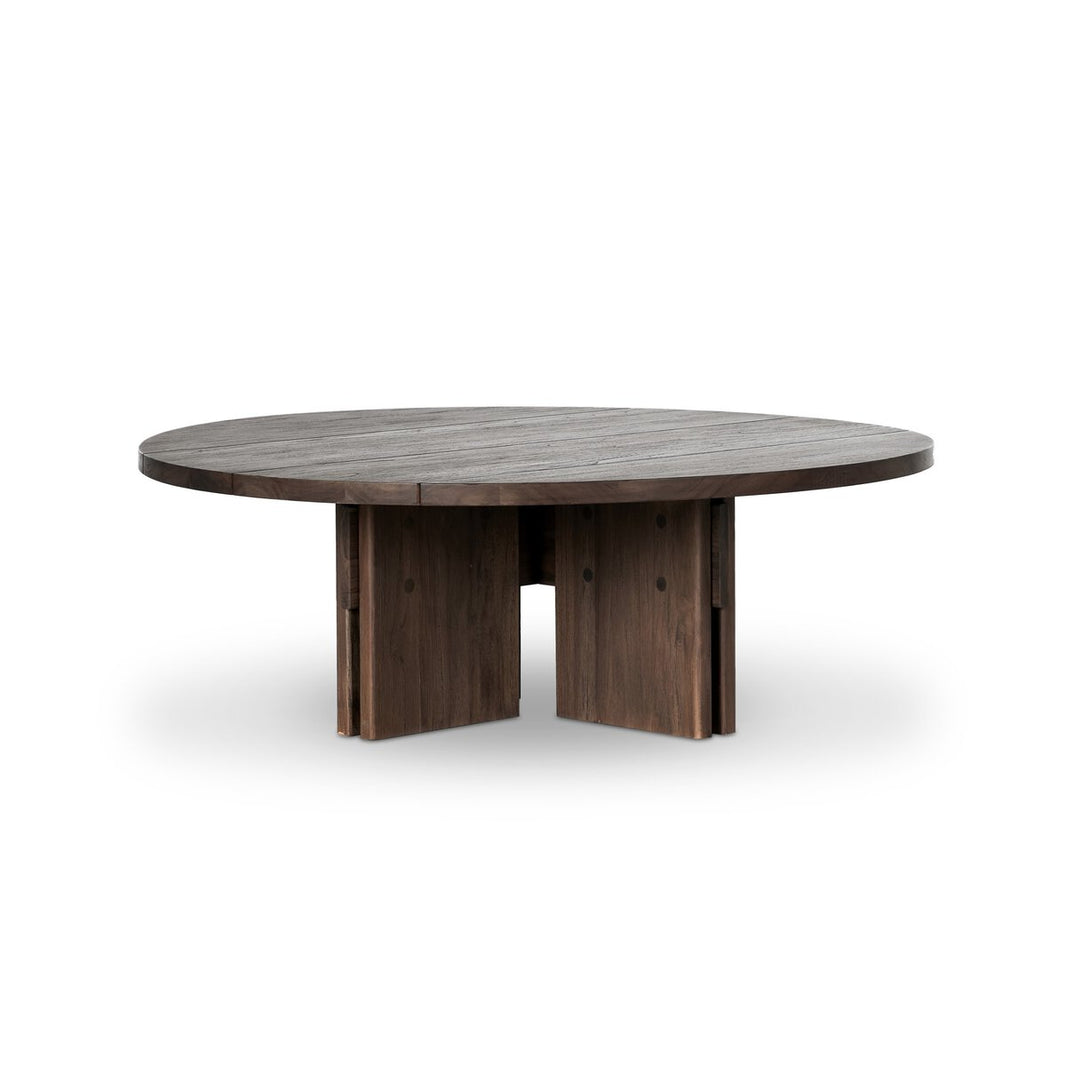 The Teak Outdoor Coffee Table features a round, thick tabletop and intersecting vertical wood panel legs, crafted from FSC-certified teak in a toasted brown finish, shown against a plain white background.