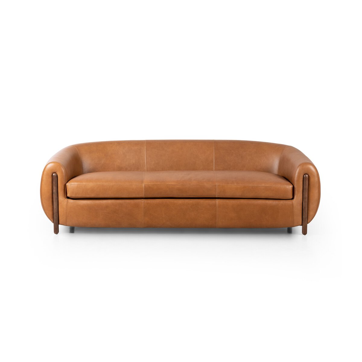 The Tub Loveseat in tan leather showcases rounded arms and backrest, clean lines, and deep seating for extra comfort, set against a plain white background.