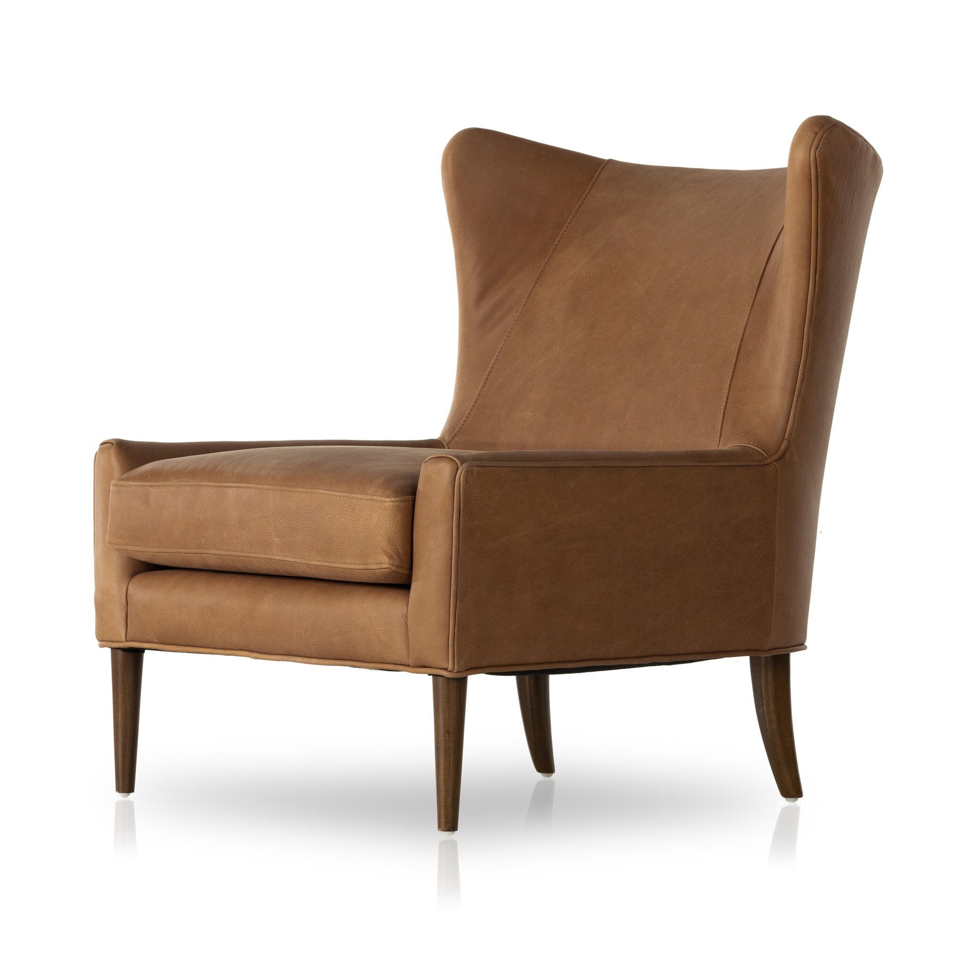 The Marlow Wing Chair, upholstered in brown leather, features a high back, angled arms, plush seat cushion, and tapered wooden legs. Its sleek design and ideal dimensions make it a standout piece against a white background.